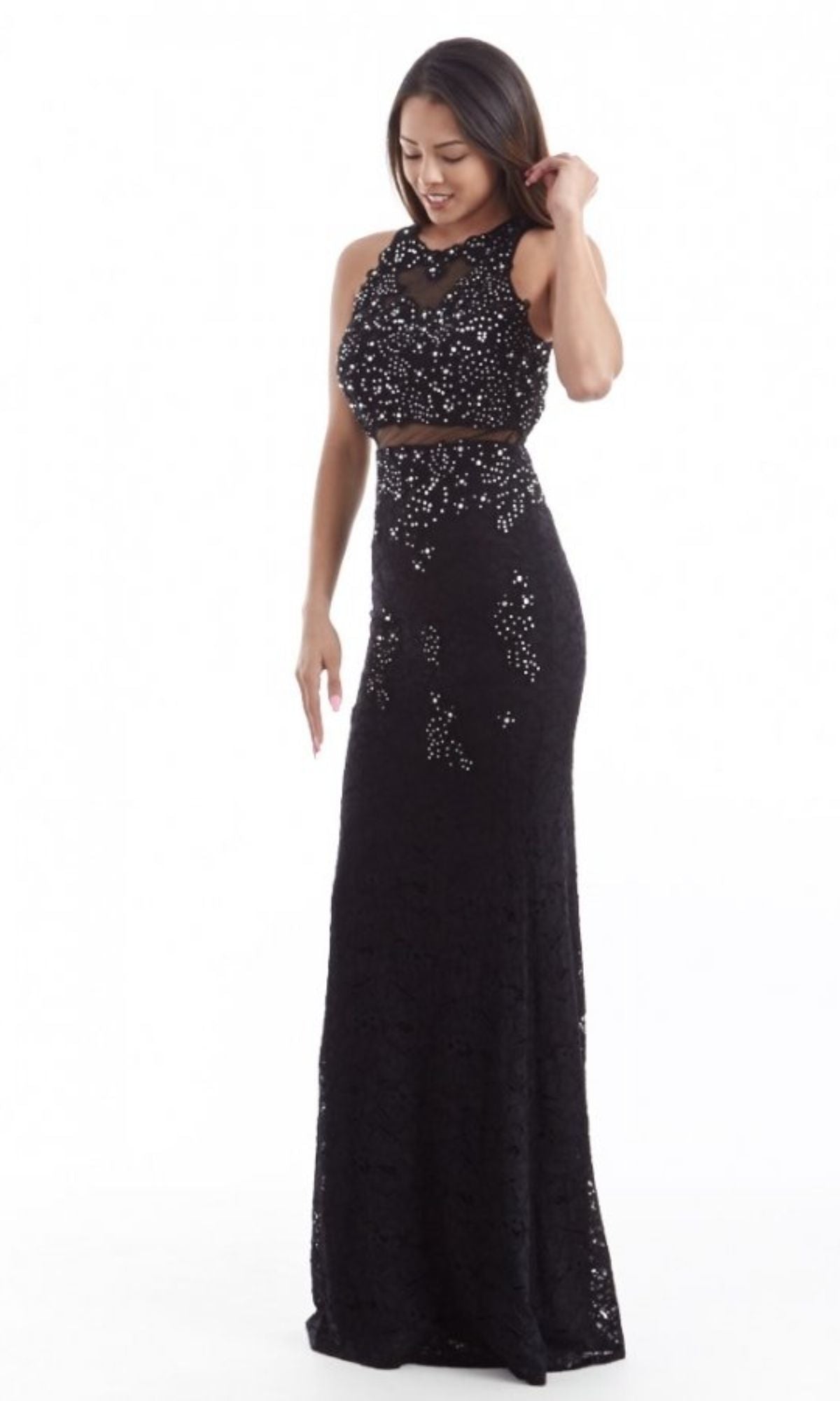 A woman wears the Chicas CR4225 Mock Two-Piece Long Lace Prom Dress, a sleeveless, floor-length black gown with sparkling details, against a white background.